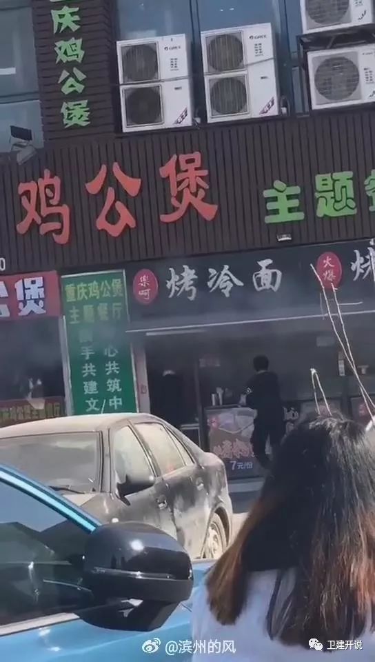 摩托车油箱着火小伙拿水灭引燃店铺